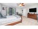 Spacious bedroom with ceiling fan, large window with curtains, and furniture at 223 Sterling Brook Ln, Canton, GA 30114