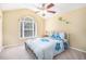 Cozy bedroom with a vaulted ceiling, ceiling fan, and a large window at 223 Sterling Brook Ln, Canton, GA 30114