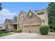 Beautiful exterior view of a two-story brick home with a two-car garage and manicured lawn at 223 Sterling Brook Ln, Canton, GA 30114