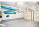 A spacious garage is shown with kayaks hanging from the ceiling and plenty of room at 223 Sterling Brook Ln, Canton, GA 30114
