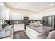 Well-lit kitchen featuring an island, stainless steel appliances, and white cabinetry at 223 Sterling Brook Ln, Canton, GA 30114