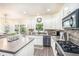 Charming kitchen featuring white cabinets, modern appliances and a view to the dining area at 223 Sterling Brook Ln, Canton, GA 30114