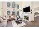 Inviting living room featuring a fireplace, tall windows, and a comfortable sectional sofa at 223 Sterling Brook Ln, Canton, GA 30114