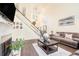 Cozy living room with a fireplace, staircase, and a comfortable sofa at 223 Sterling Brook Ln, Canton, GA 30114