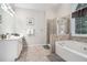 Main bathroom features a vanity, shower, garden tub, and tile flooring at 223 Sterling Brook Ln, Canton, GA 30114