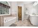 Main bathroom with large garden tub, ceramic tiled floor and granite counter top at 223 Sterling Brook Ln, Canton, GA 30114