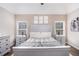 Spacious main bedroom featuring a king bed, ensuite bathroom and hardwood floors at 223 Sterling Brook Ln, Canton, GA 30114