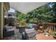 Relax in style on the deck's comfortable gray wicker seating area, shaded by a large canopy, surrounded by nature at 223 Sterling Brook Ln, Canton, GA 30114