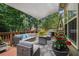 Back patio features outdoor furniture, a grill, and shade covering with view of greenery at 223 Sterling Brook Ln, Canton, GA 30114