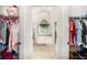 View of bathroom with garden tub, seen from between walk-in closets with ample storage at 223 Sterling Brook Ln, Canton, GA 30114