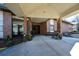 Inviting entrance with covered walkway, rocking chairs, and well-kept landscaping at 475 Mount Vernon Ne Hwy # C-220, Sandy Springs, GA 30328