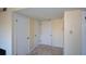 Neutral hallway with carpet and white doors offers a versatile living space at 475 Mount Vernon Ne Hwy # C-220, Sandy Springs, GA 30328