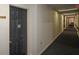 Clean hallway with neutral walls and carpet. Black door and overhead lighting at 475 Mount Vernon Ne Hwy # C-220, Sandy Springs, GA 30328