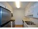 Galley kitchen features stainless steel appliances and plenty of cabinet space at 475 Mount Vernon Ne Hwy # C-220, Sandy Springs, GA 30328