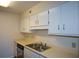 Galley kitchen features stainless steel sink, dishwasher and plenty of cabinet space at 475 Mount Vernon Ne Hwy # C-220, Sandy Springs, GA 30328