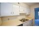 Bright kitchen showcasing white cabinetry and stainless steel sink at 475 Mount Vernon Ne Hwy # C-220, Sandy Springs, GA 30328