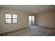Bright living room features neutral carpeting, large window and sliding door access at 475 Mount Vernon Ne Hwy # C-220, Sandy Springs, GA 30328