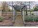 Backyard wooden arbor on wooded lot surrounded by privacy fence at 4908 Mill Brook Dr, Atlanta, GA 30338
