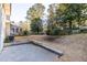 Outdoor living space with a concrete patio and retaining wall in a big backyard at 4908 Mill Brook Dr, Atlanta, GA 30338