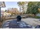 Spacious backyard featuring a concrete patio, mature trees, and a wooden fence at 4908 Mill Brook Dr, Atlanta, GA 30338