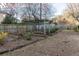 Large backyard area with a pergola, wooden border, and lush greenery at 4908 Mill Brook Dr, Atlanta, GA 30338