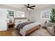 Tranquil bedroom with hardwood floors, a ceiling fan, neutral decor, and natural light at 4908 Mill Brook Dr, Atlanta, GA 30338