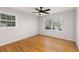 Well-lit bedroom with hardwood floors, two windows, and neutral wall color at 4908 Mill Brook Dr, Atlanta, GA 30338