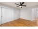 Spacious bedroom showcasing hardwood floors, closet space, and a ceiling fan at 4908 Mill Brook Dr, Atlanta, GA 30338