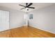 Bright bedroom featuring hardwood floors, a ceiling fan, and a window providing natural light at 4908 Mill Brook Dr, Atlanta, GA 30338