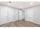 Bright bedroom with hardwood floors, multiple closets, and white painted trim and doors at 4908 Mill Brook Dr, Atlanta, GA 30338