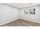Bedroom featuring new flooring and a window, with neutral color at 4908 Mill Brook Dr, Atlanta, GA 30338