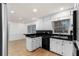 Kitchen with white cabinets, black countertops and backsplash, and tile flooring at 4908 Mill Brook Dr, Atlanta, GA 30338