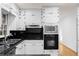 Contemporary kitchen with white cabinets, black countertops, and stainless steel appliances at 4908 Mill Brook Dr, Atlanta, GA 30338