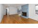 Bright living room with light wood floors, a blue brick fireplace, and sliding glass doors at 4908 Mill Brook Dr, Atlanta, GA 30338