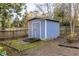 Backyard shed with double doors in a well-maintained yard with mature trees at 4908 Mill Brook Dr, Atlanta, GA 30338