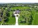 Aerial view of a luxurious estate with a circular driveway, fountain, and beautiful landscaping at 5661 Rutland Trce, Lithonia, GA 30058