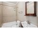 Cozy bathroom featuring a bathtub, tiled shower, and vanity with decorative mirror at 5661 Rutland Trce, Lithonia, GA 30058