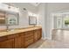 Bathroom with dual sinks, granite countertops, and wood cabinets at 5661 Rutland Trce, Lithonia, GA 30058