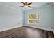 Bedroom with wood floor features ceiling fan, crown molding, and natural light from window at 5661 Rutland Trce, Lithonia, GA 30058