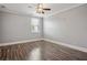 Bedroom features wood floor, ceiling fan, crown molding, and natural light from window at 5661 Rutland Trce, Lithonia, GA 30058
