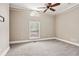Bright bedroom with carpet, a ceiling fan, and large windows with natural light at 5661 Rutland Trce, Lithonia, GA 30058