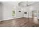 Large bedroom with hardwood floors, tray ceilings, and a cozy fireplace at 5661 Rutland Trce, Lithonia, GA 30058