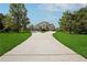 Long driveway leading to a stunning brick home surrounded by a lush green lawn at 5661 Rutland Trce, Lithonia, GA 30058