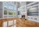 Bright living room featuring hardwood floors, large windows, and a charming fireplace at 5661 Rutland Trce, Lithonia, GA 30058