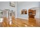 Spacious room with hardwood floors, arched entryways, and views into the kitchen at 5661 Rutland Trce, Lithonia, GA 30058
