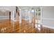 Open-concept living space with hardwood floors, arched entryways, and elegant staircase at 5661 Rutland Trce, Lithonia, GA 30058