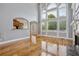 Bright living room featuring hardwood floors, a fireplace, and large windows at 5661 Rutland Trce, Lithonia, GA 30058