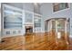 Living room with custom built-ins, cozy fireplace, and gleaming hardwood floors at 5661 Rutland Trce, Lithonia, GA 30058