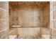 Luxurious shower with natural stone tile, integrated seating, and mosaic floor at 5661 Rutland Trce, Lithonia, GA 30058