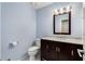 Bathroom with marble vanity, dark brown cabinets, and modern lighting at 1378 Sheffield Glen Ne Way, Atlanta, GA 30329